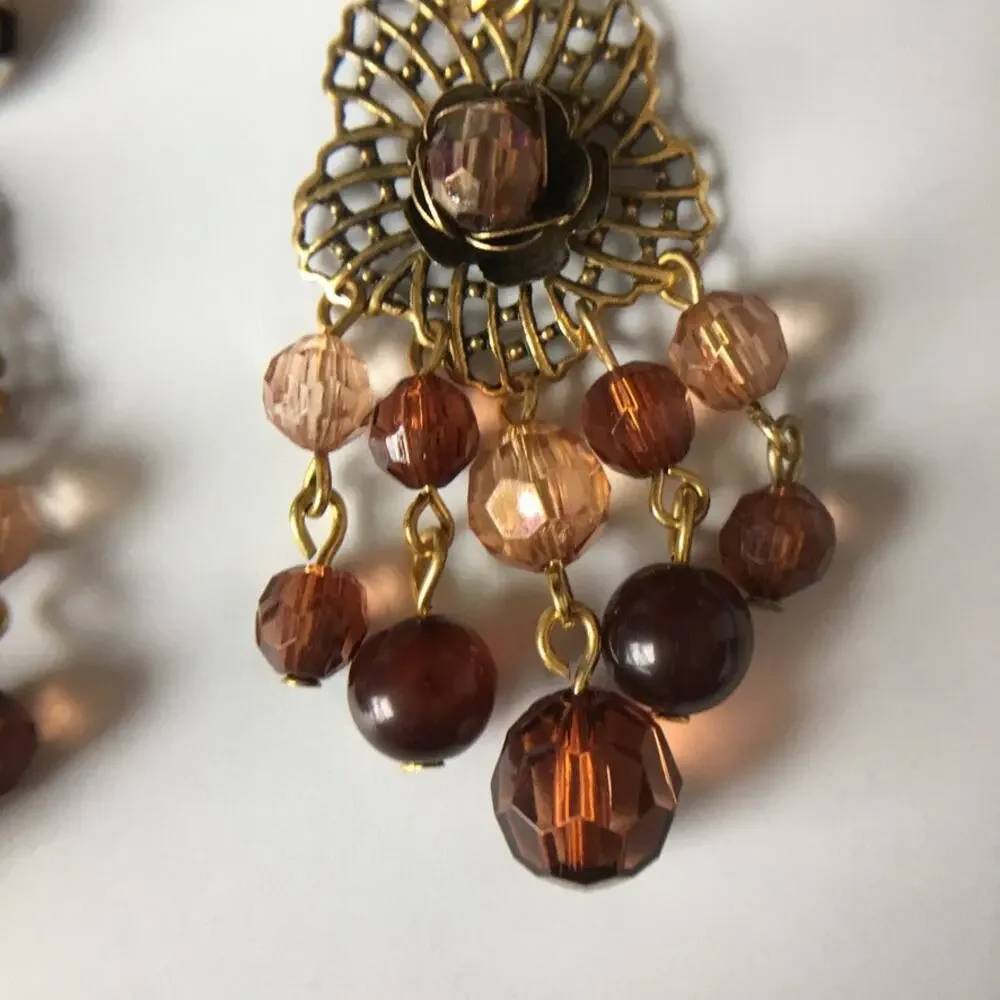 Darling ornate clip on earrings with beaded accents in amber/garnet tones